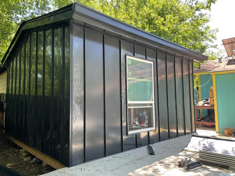 Black standing seam metal wall panels for Roof Inspection in Progress Village