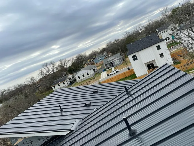 Standing seam metal roof panels with vents for Skylight Repair in Progress Village